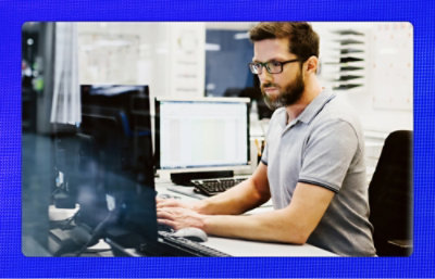 A person sitting at a desk using a computer.