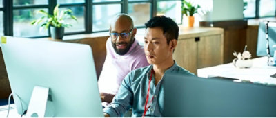A group of men looking at a computer screen.
