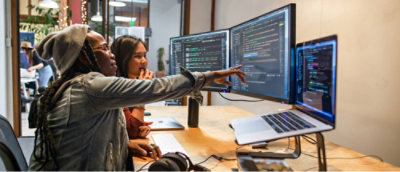 A group of people looking at a computer screen.