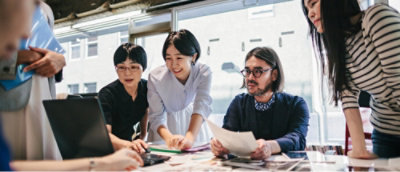 A group of people looking at a screen