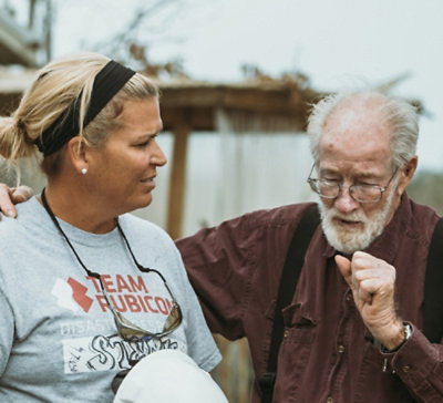 A man and a woman standing next to each other, with visible text reading STEAM and PRUBICON.