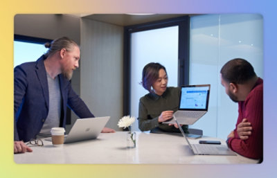 Two man and one women working on laptop.