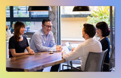 Two man and two women sitting on the table and discussing to each other