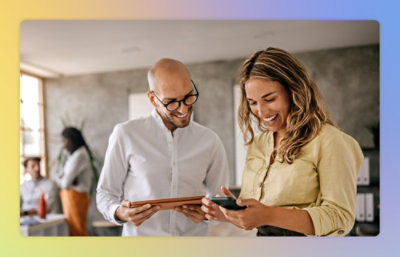 A man and women looking in the mobile and tablet screen.