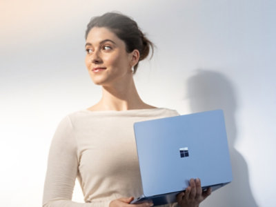 A woman holding a laptop.
