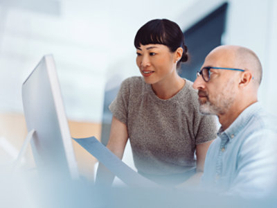 A guy and a woman viewing the computer screen