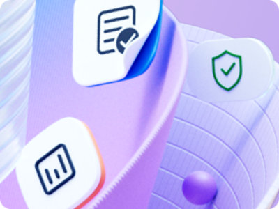 A person sits at a desk with three screens, typing on a laptop. The screens display lines of code. 