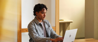 A woman with blonde hair and a blue shirt clapping her hands.