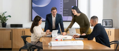 A man and woman looking at a laptop.