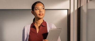A woman standing with a laptop