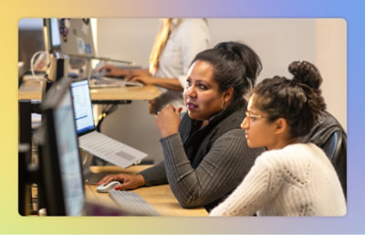 A woman sitting at a desk using a computer.