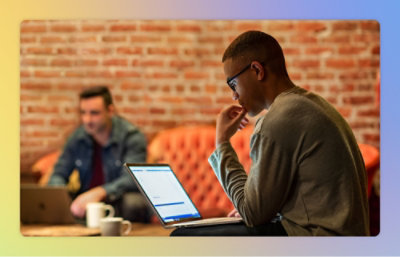 A man sitting at a table with a laptop.