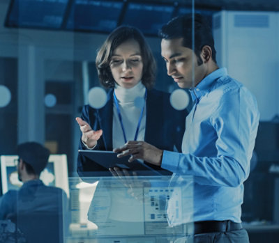 A men and women discussing while looking into tab