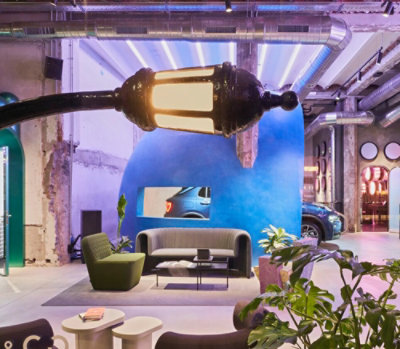 A living room with a couch and a lamp.