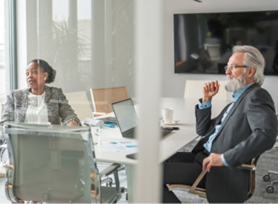 A man and woman sitting in a office room
