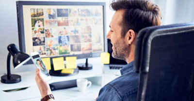A person sitting in a chair looking at a computer screen