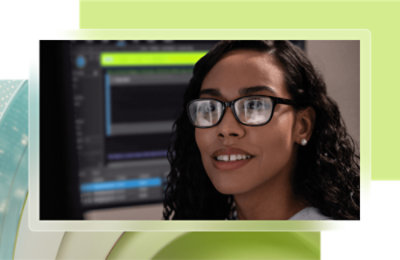 A woman wearing glasses and smiling.