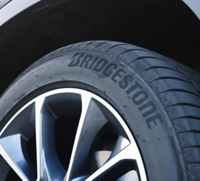 Close-up of a bridgestone tire on a car's alloy wheel.