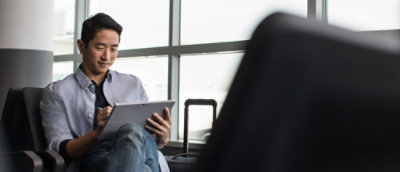 A man sitting in a chair with his legs crossed.
