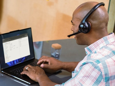 A man is wearing headphone and working.