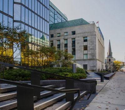 A stone building with a staircase and a steeple
