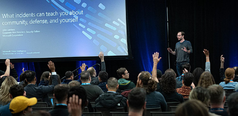 A person standing in front of a large screen with a screen on it Description automatically generated