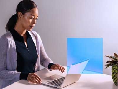 A woman looking at a laptop screen.