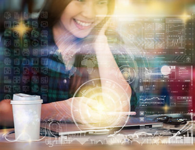 A woman types on her smartphone with various digital data and analytics graphics superimposed over the image.