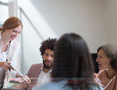 A woman standing in front of a group of people.