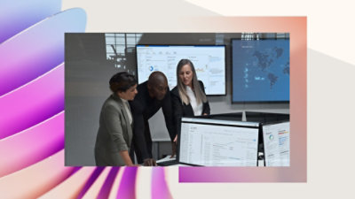 A group of people looking at a computer screen.