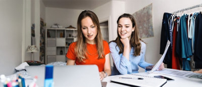 A couple of women looking at a computer