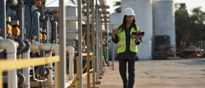 A person wearing a yellow safety vest and a hard hat.