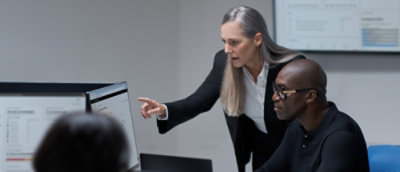 A man and a women checking something in a desktop