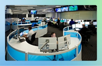 Image of a workplace where people are working on their respective systems