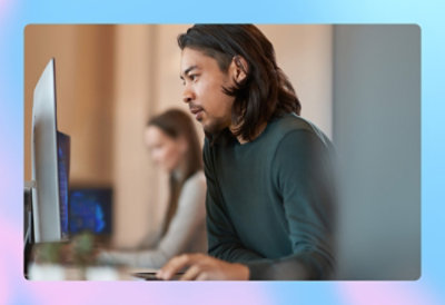 A person sitting at a desk using a computer
