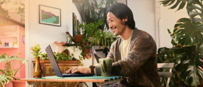 A person sitting at a table with a laptop.