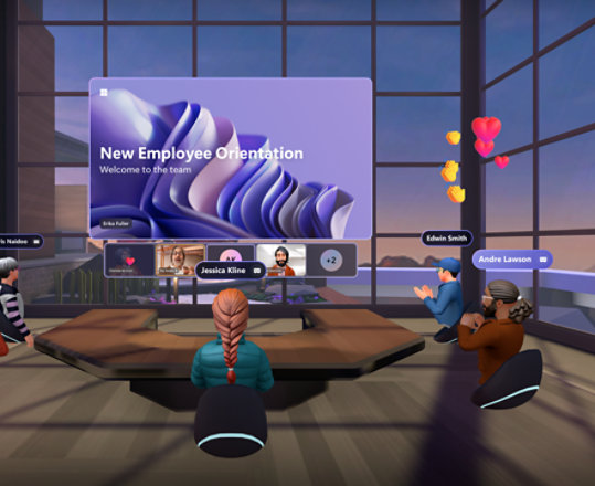 Mesh avatars sitting around a U-shaped conference table watching a presentation and reacting with emojis