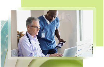 A doctor and a nurse looking at a computer screen.