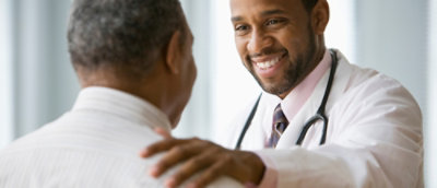 A close-up of a doctor wearing a white coat.