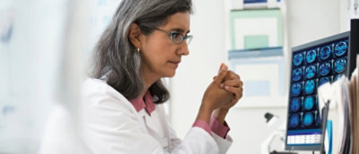 A woman in a white coat.