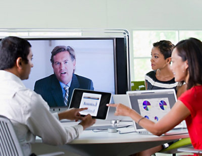 A man in a suit talking to a group of people.