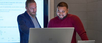 Two people collaborating at computer workstation
