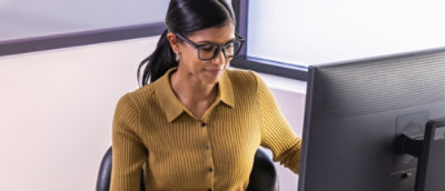 Person working at desktop computer in office