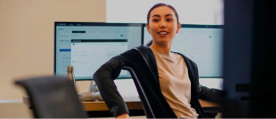 A women sitting on office chair and looking somewhere.