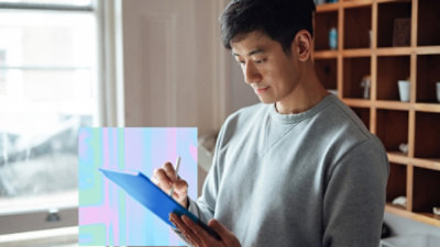 A person holding a blue clipboard.