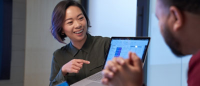 A person pointing at a laptop screen.