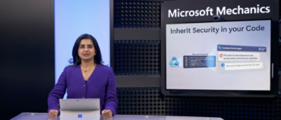  A women sitting in front of a screen where microsoft mechanics is written