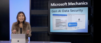 A women sitting in front of a screen where microsoft product is displaying