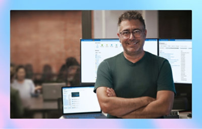 A peson standing in front of computer screen