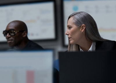 A group of people sitting in front of computers.